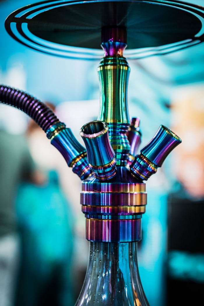 Vibrant, multicolored hookah captured in unique close-up with soft background.